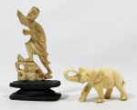 Lote constando de duas peças orientais em marfim esculpido sendo (A) elefante com a tromba para cima, dito da sorte, med: 4 cm x 6 cm (B) Pescador com base em madeira entalhada e policroma. med: 9 cm (no estado)