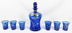 Conjunto constando de garrafa licoreira e seis copinhos circa 1950, em vidro europeu na cor azul cobalto, decoração floral  aplicadas a prata. med: 21 cm (garrafa) 6 cm (copinhos)