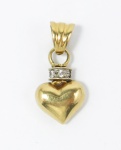 Pingente no formato de coração em ouro, teor 18 kl, cravejado de brilhantes. PT: 2,4 gramas