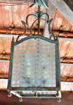Luminária de varanda com armação em ferro e vidro translúcido  com desenhos geométricos , medindo 0,45cm de alt., 0,22cm de larg., 0,22cm de prof. (OBS: Medida da altura não inclui corrente)